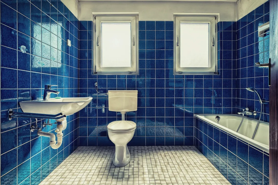 Badezimmer mit blauen Fliesen im Originalzustand